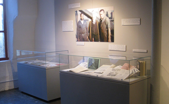 Art gallery with archival materials in glass case 